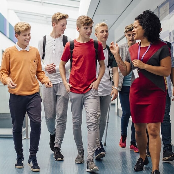 students walking in hallway with teacher